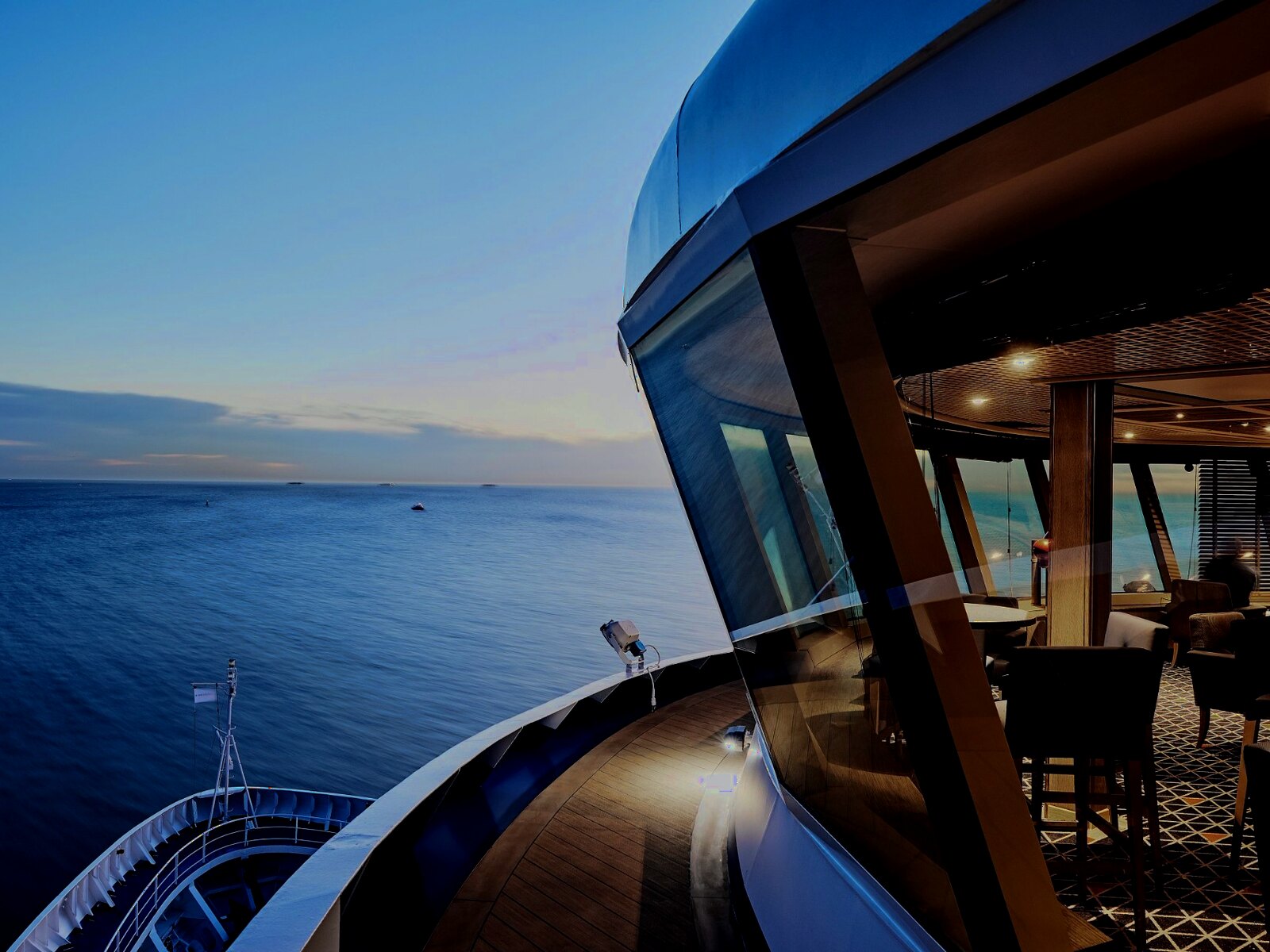 Forward observation lounge overlooking open sea at twilight